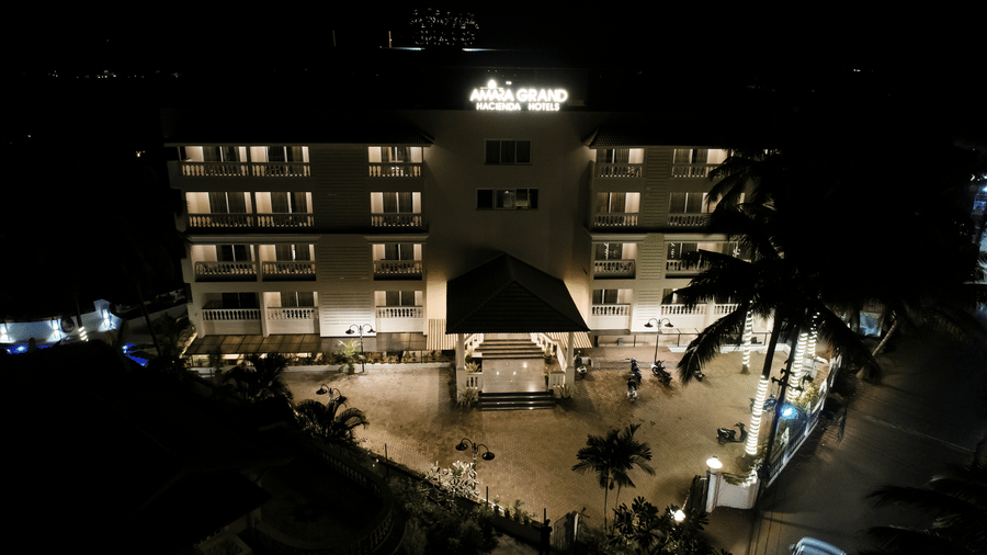 Top view of Amara Grand Baga, Goa, illuminated by the glow of lights from within the building.