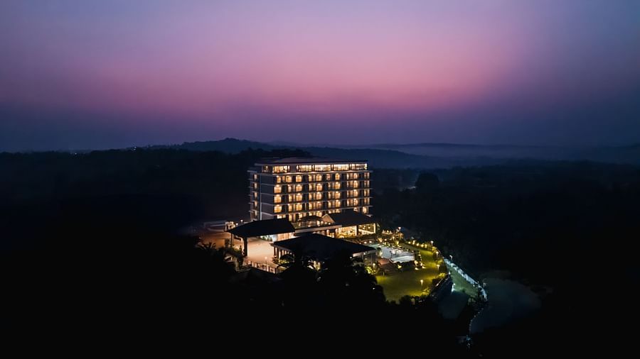 an aerial view of Cloud9 Sarovar Premiere, Palolem Goa during twilight with the lights on.