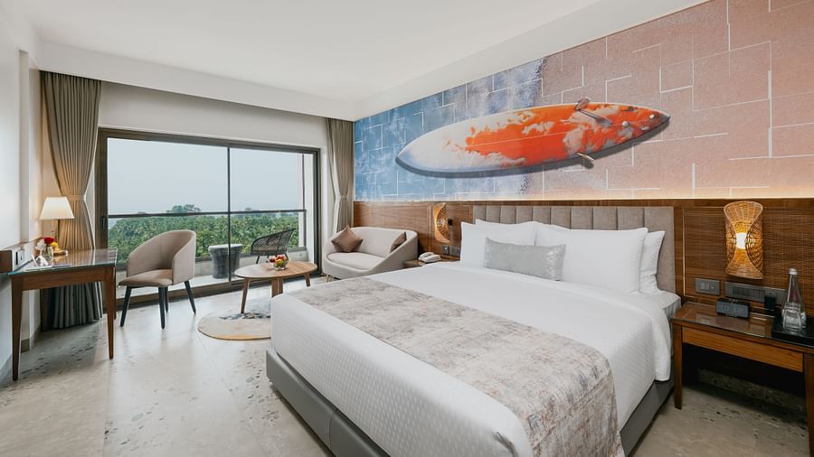 an image of a bedroom with a balcony view at Cloud9 Sarovar Premiere, Palolem Goa