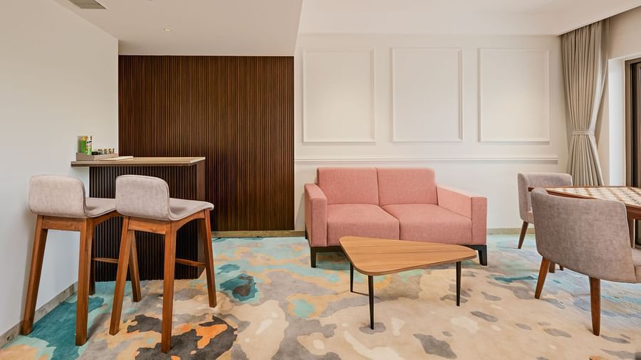 an image of living area of a suit with a sofa and a patterned carpet at Cloud9 Sarovar Premiere, Palolem Goa