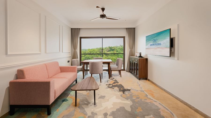 an image of a suit with a sofa and table with a balcony at Cloud9 Sarovar Premiere, Palolem Goa