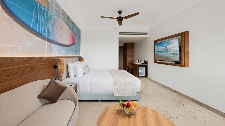 an image of a bedroom with a wall mounted television and a fan hanging from the ceiling at Cloud9 Sarovar Premiere, Palolem Goa