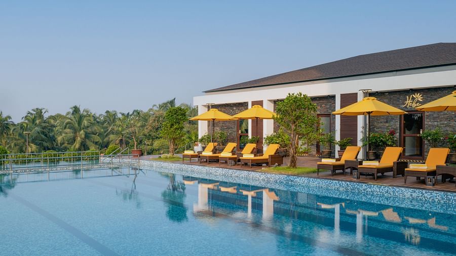 an image of a swimming pool with sun loungers at Cloud9 Sarovar Premiere, Palolem Goa