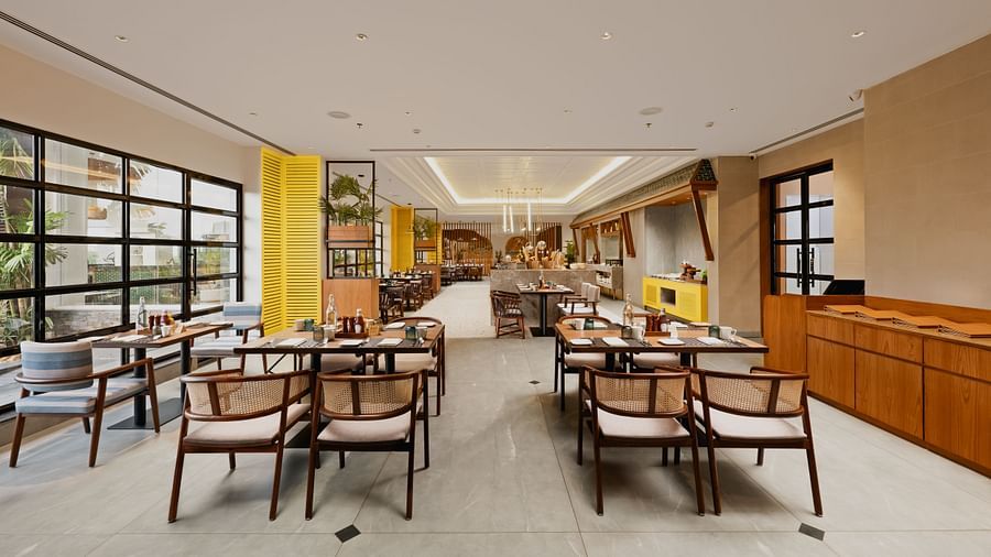 an image of a dining space with cutlery set placed on the table at Cloud9 Sarovar Premiere, Palolem Goa