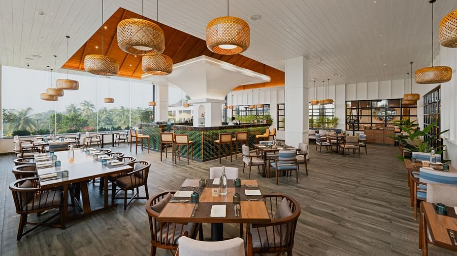 Rooftop dining space with plants arranged in the corners at Cloud9 Sarovar Premiere, Palolem Goa