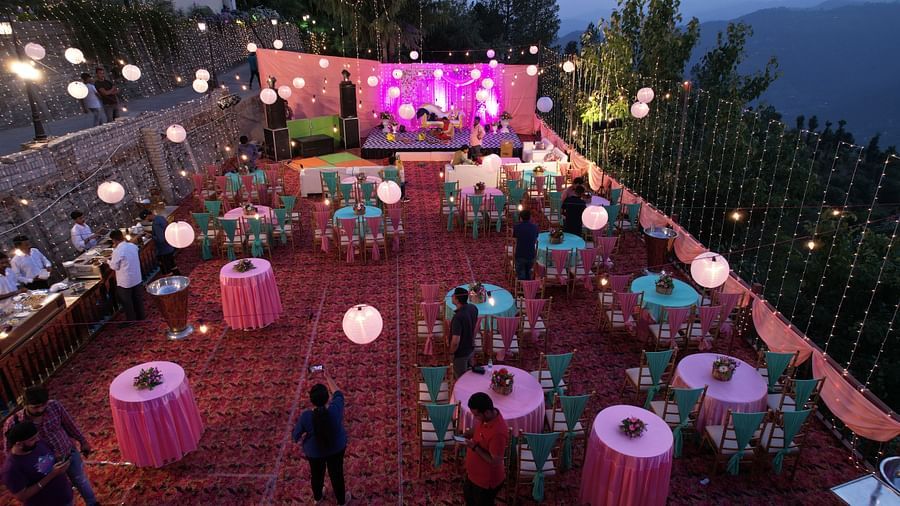 A nighttime shot of a well decoarted wedding venue bustling with guests
