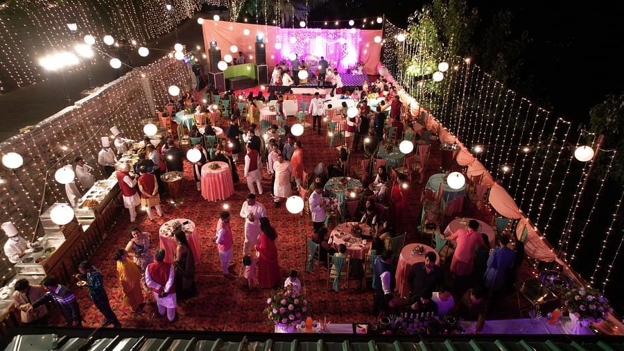 A nighttime shot of a wedding venue bustling with guests.