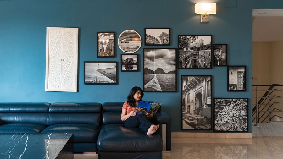An overview of the living room with a woman reading a book inside Humming Bird Villa - Karma Lakelands.