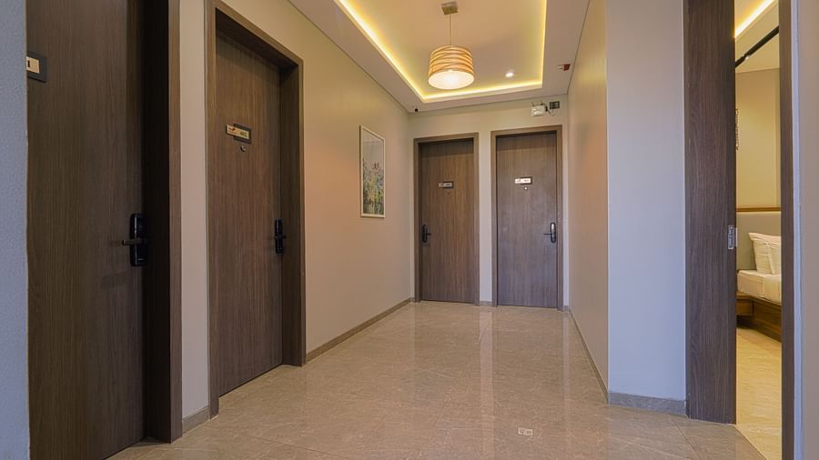 An image of lobby where several doors of rooms can be seen, and on top there are lighting fixtures on the ceiling - Fortune House, Magarpatta