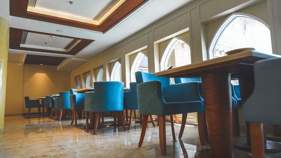 An image of seating area with sofa sets and a centre table placed in a room -  The Garden Ananta Elite, Rajkot