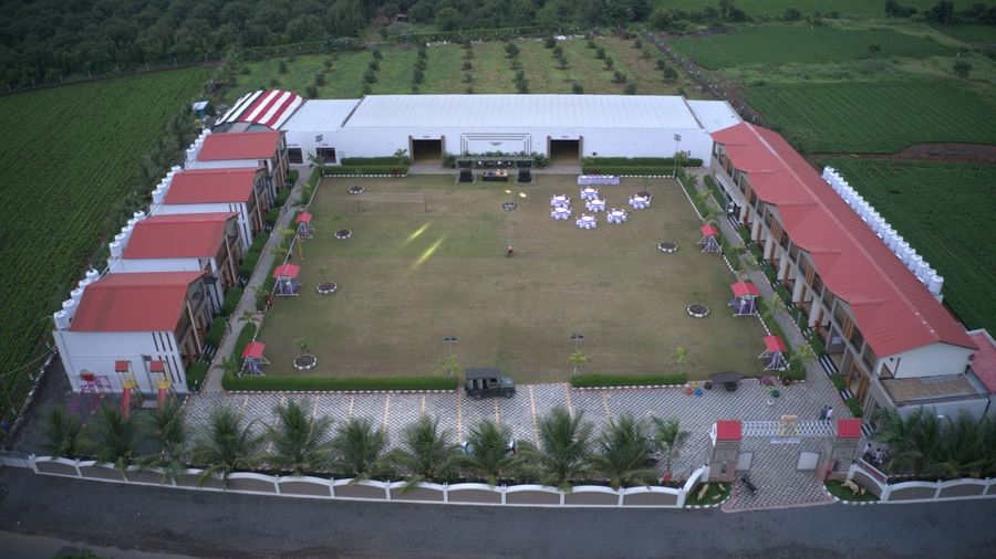 Drone view of VITS Select Diamond Resort, Sasan Gir showing the open courtyard with event setup and red-roofed blocks around.