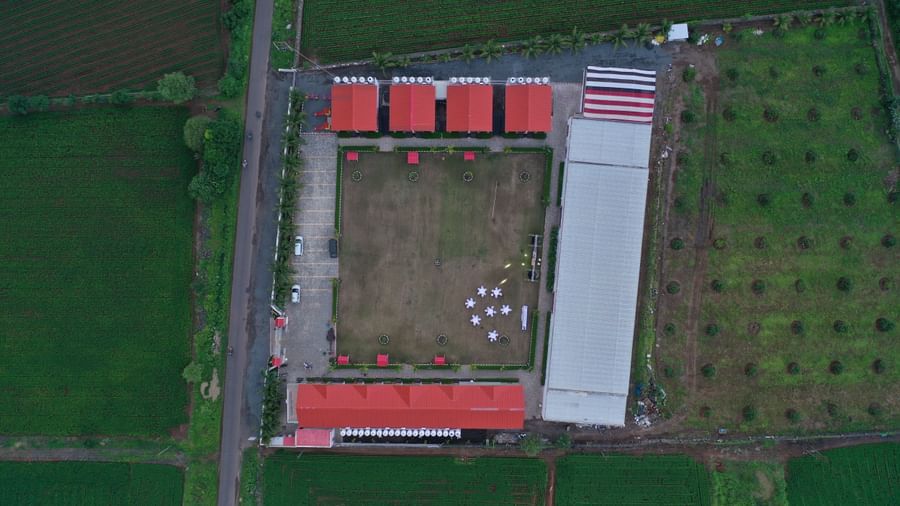 Top-down drone view of VITS Select Diamond Resort, Sasan Gir showing rectangular property layout, event area, and surrounding greenery.
