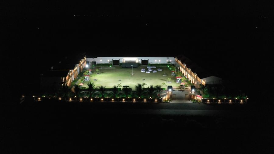 Aerial night shot of VITS Select Diamond Resort, Sasan Gir showing the lit-up rectangular courtyard and building outline.