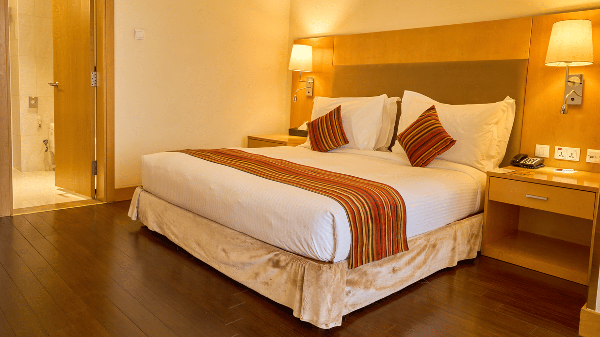  A close view of  bedroom with comfortable bed, bedside tables, lamps, and warm lighting creating cosy atmosphere - Ramada by Wyndham Addis