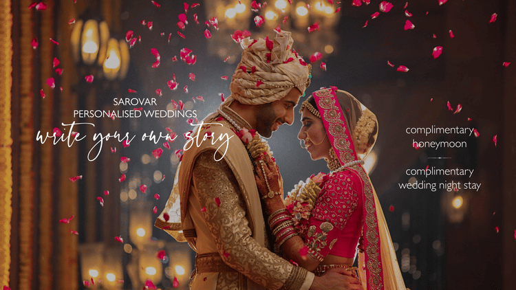 Newly wed couple embracing each other in a decorated area and flower petals are falling on them. The background in the banner says write your own story as sarovar promised personalised wedding, free wedding night stay, and honeymoon.