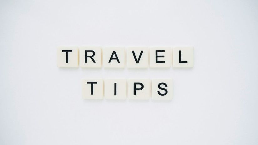 Travel Tips written in scrabble tiles as seen from above.