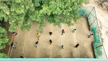 An overhead shot captures people playing human foosball in a court - District Gravity Adventure Park, Hyderabad