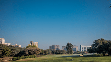 An overview of the golf course with buildings and trees in the background at Karma Lakelands