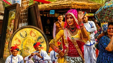 An image of a group of folk artist of Rajasthan in their traditional attire ready for a performance