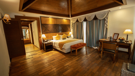 A bedroom with wooden interior and dim lights highlighting the architecture.