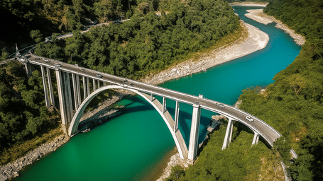 A modern bridge arching gracefully over a turquoise river, set against a backdrop of dense green forests, showcasing remarkable engineering and nature.