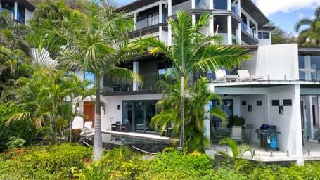 An exterior view of the private residences accommodations at Tamarind Hills Resort and Villas, Antigua,  a luxury resort in Antigua surrounded by tropical greenery.