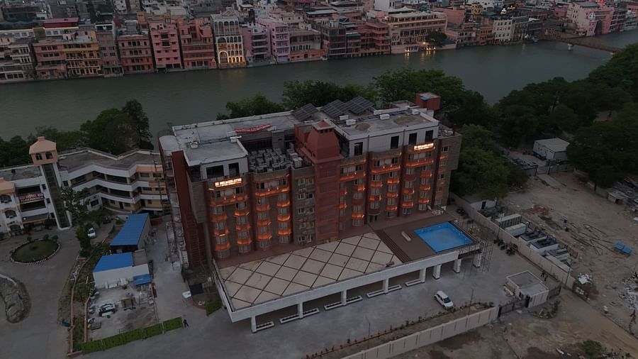 A bird's eye view of Bhagirathi by RDB Atishay featuring the exterior of the hotel with the Ganges flowing behind it.