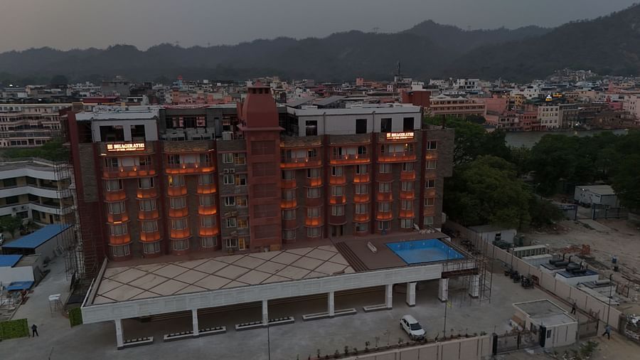 DJI 20250501211435 0039 D (1)Drone shot of the exterior of Bhagirathi by RDB Atishay during the evening hours with a mountain ranges in the background.