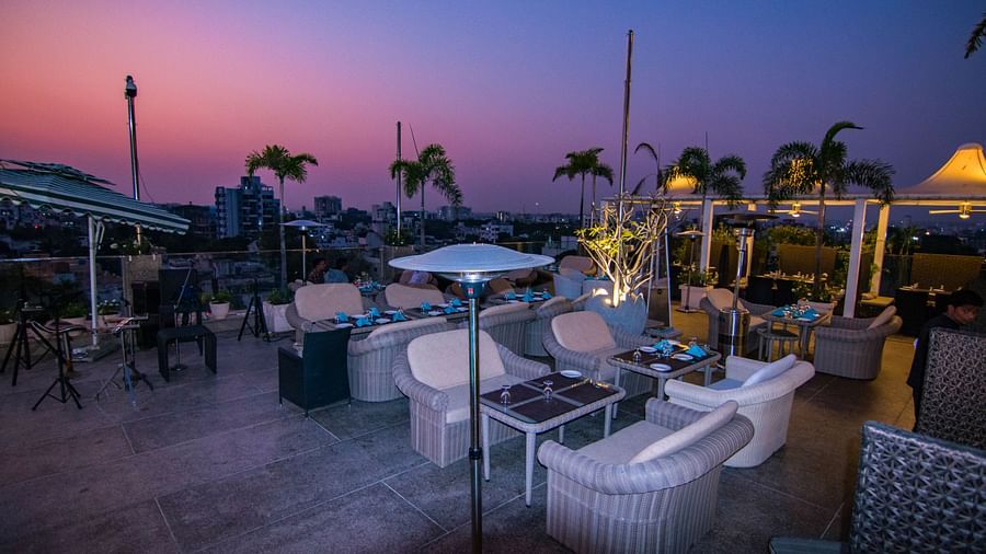 An outdoor dining setup at dusk at Hotel Ashok Nagpur.
