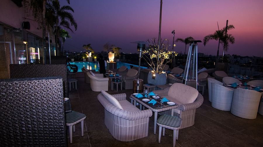 An outdoor furniture setup of a restaurant at Hotel Ashok Nagpur.