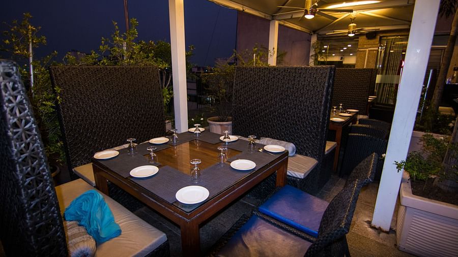 An outdoor dining setup at a restaurant at Hotel Ashok Nagpur.