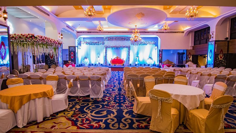 Kohinoor showcasing the stage backdrop and round tables with ambient lighting.