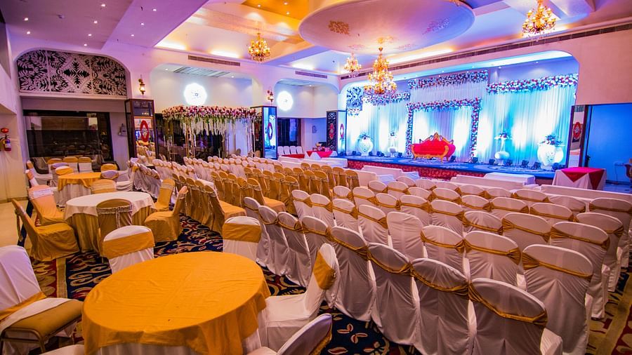 Kohinoor displaying rows of chairs and tables ready for an event, with a view of the stage.