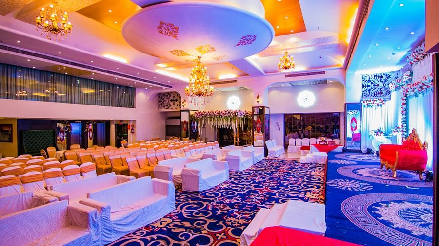 Kohinoor highlighting the stage area and rows of chairs facing the stage.