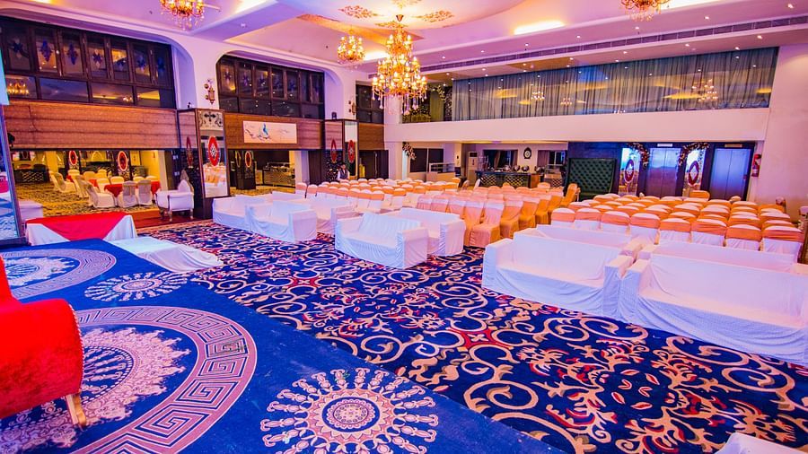 Kohinoor showcasing rows of chairs facing the stage with patterned flooring and ambient lighting.