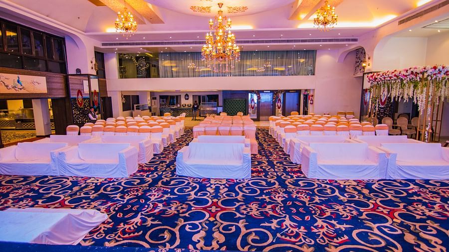 Kohinoor featuring blue patterned carpet and rows of chairs.