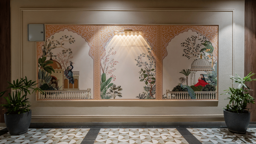 A large wall painting showing a traditional gazebo, 2 potted plants, and patterned floor tiling at Hotel Highway King, Harmada.