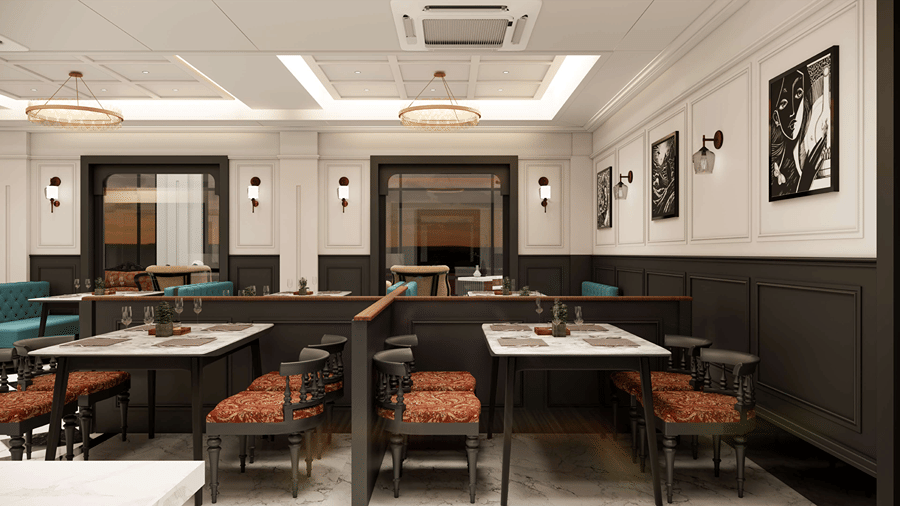 Modern resort dining venue featuring dark-paneled walls, comfortable cushioned seating, square dining tables, and warm overhead lighting.