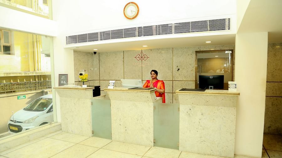 Reception area of Mango Hill Central, Chennai featuring a lady at the reception desk