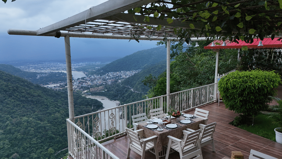 Chairs and table arranged on a rooftop for dining at Neer Ganga.