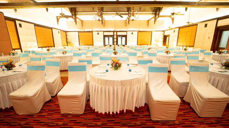 Trafalgar Square banquet hall at Ocean Spray, Puducherry featuring a cluster seating arrangement with one round table and multiple chairs.