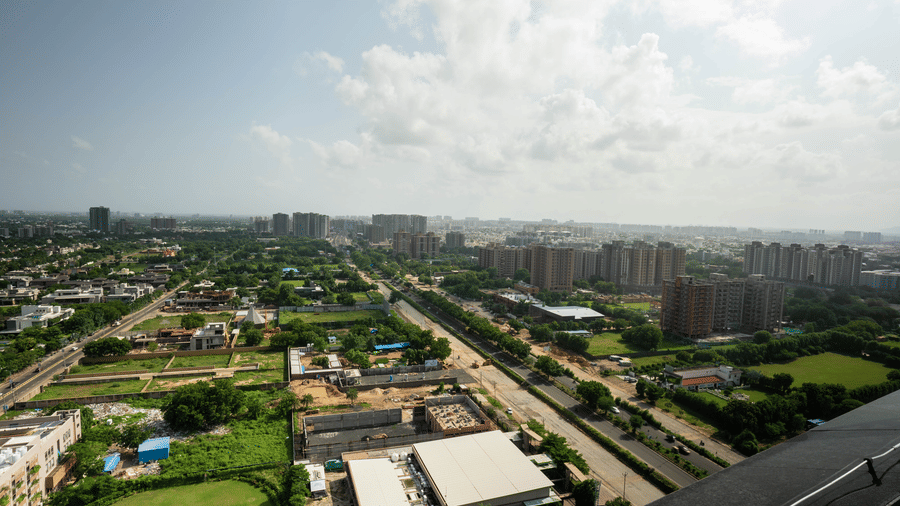 A wide aerial perspective showing the sprawling city roads and green neighbourhoods of Ahmadabad - Praveg's Grand Eulogia, Ahmedabad