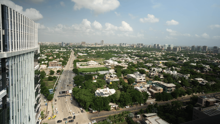 A high-angle aerial view of the Ahmadabad's cityscape and lush greenery from a high-rise building - Praveg's Grand Eulogia, Ahmedabad