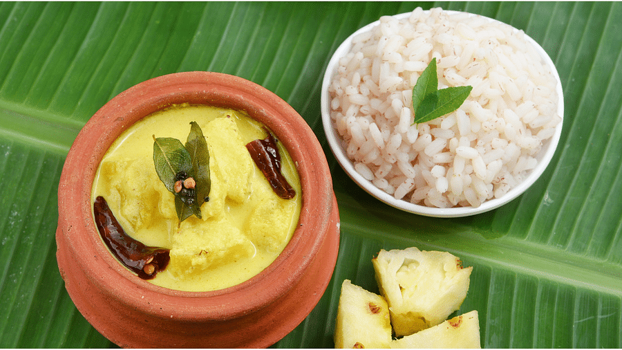 a view from above of White rice and curry on banana leaf - Rhythm Kumarakom