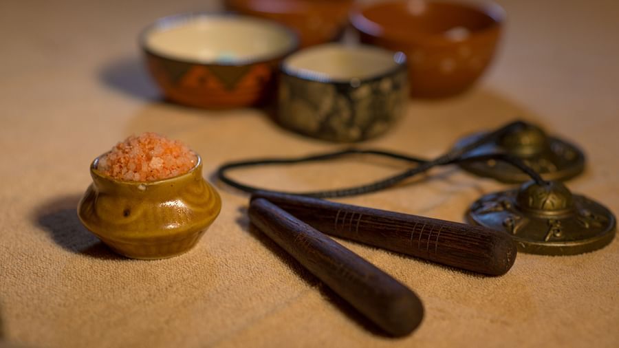 an image of a pink bath salts in a platter with other artefacts - Rhythm Lonavala