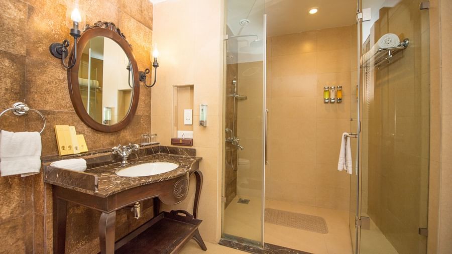 an image of a bathroom with glass shower cubicle inside one of our rooms - Rhythm Lonavala