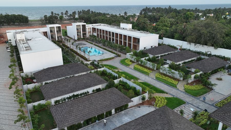 A drone shot of The Shore Trishvam, Pondicherry highlighting all the villas and rooms with lush green lawns scattered arround.