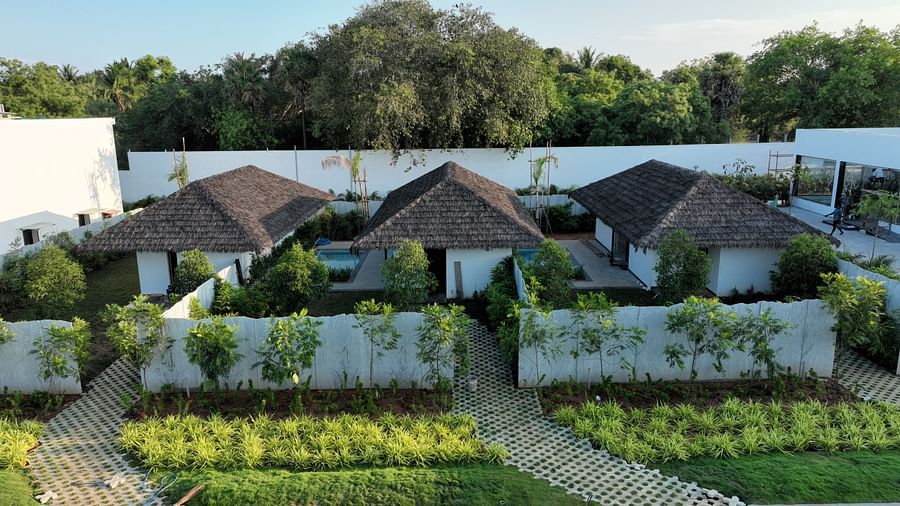 Exterior shot of three cottages with small lush green lawns in front of them at The Shore, Trishvam.