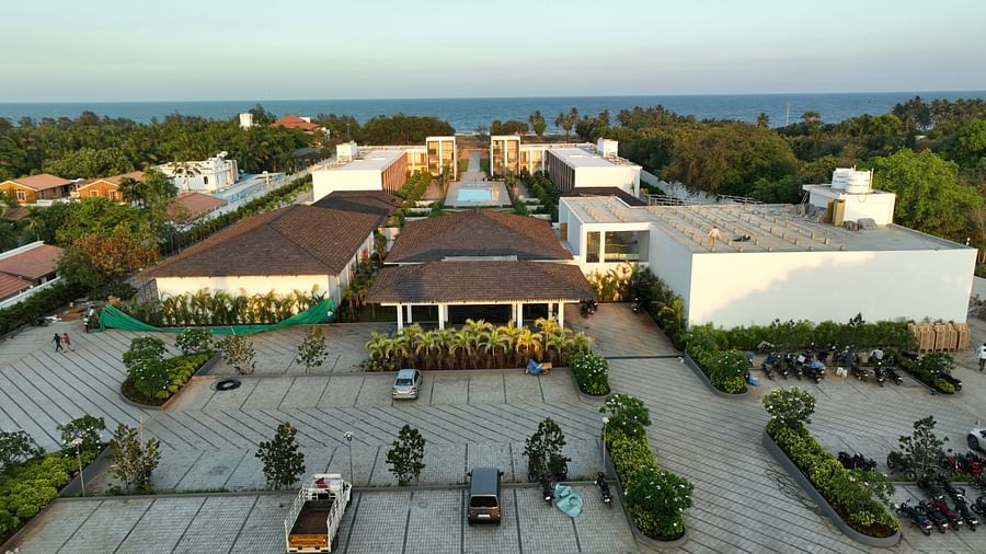 A birds eye view of the open parking space at The Shore Trishvam, Pondicherry with the ocean at the far end in the background.