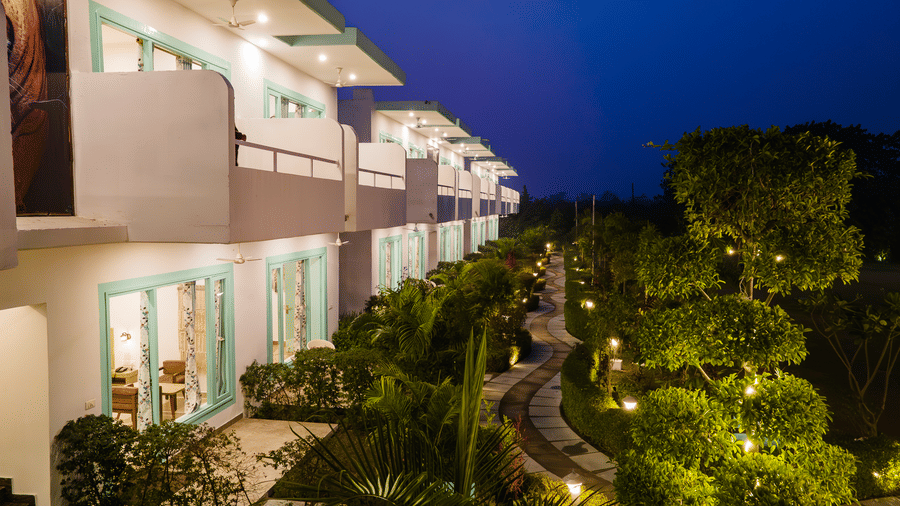 Two storey building at Vedikant Resorts The Mallard Corbett featuring rooms with outdoor views of plants and trees.